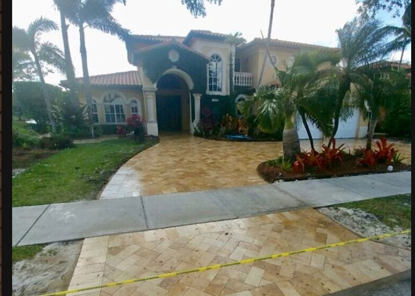 Miami home with paver driveway and manicured green landscaping, an All Around Turf & Pavers project