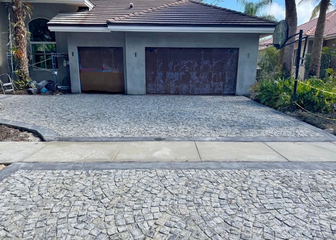 Silver paver driveway with two-car garage, All Around Turf & Pavers