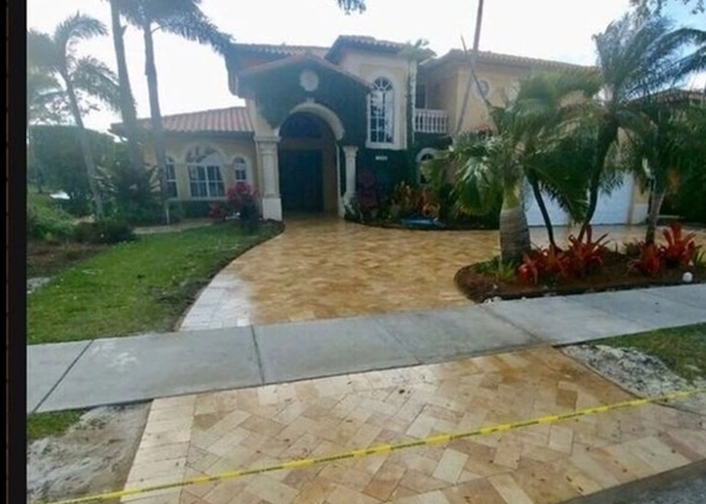 Finished travertine paver driveway in front of a Miami home, an All Around Turf & Pavers project